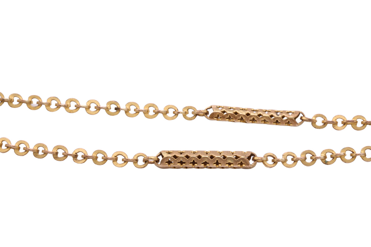 Antique rolled gold guard chain displayed on an antique jewellery box