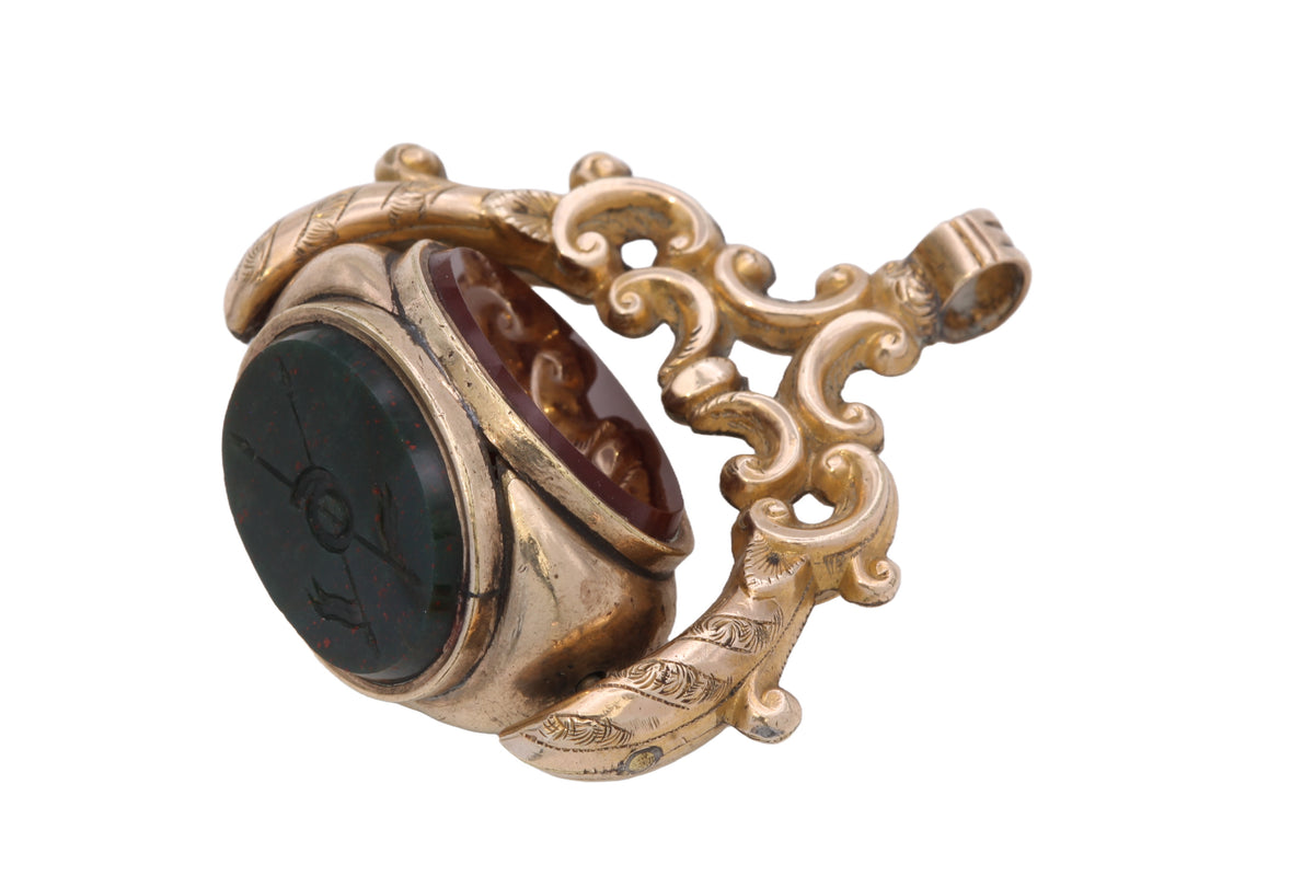 Side view of Victorian triple-face spinner fob with ornate openwork mount