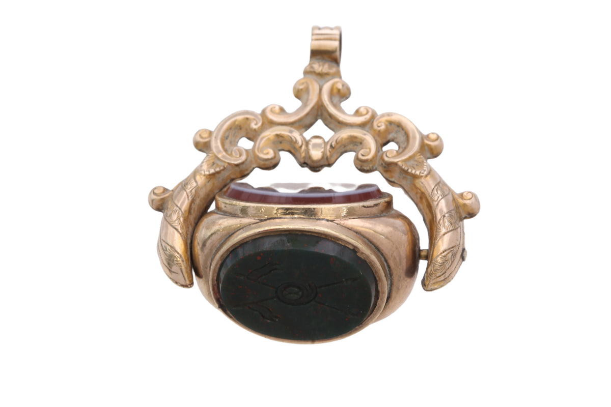 Antique spinner showing three rotating agate faces within decorative gold filled frame