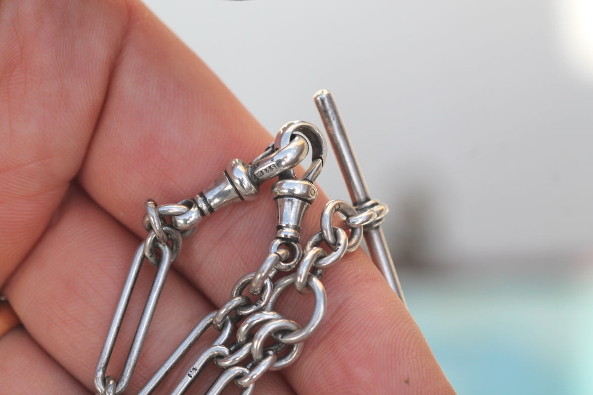 Sterling silver trombone double Albert chain shown in the hand