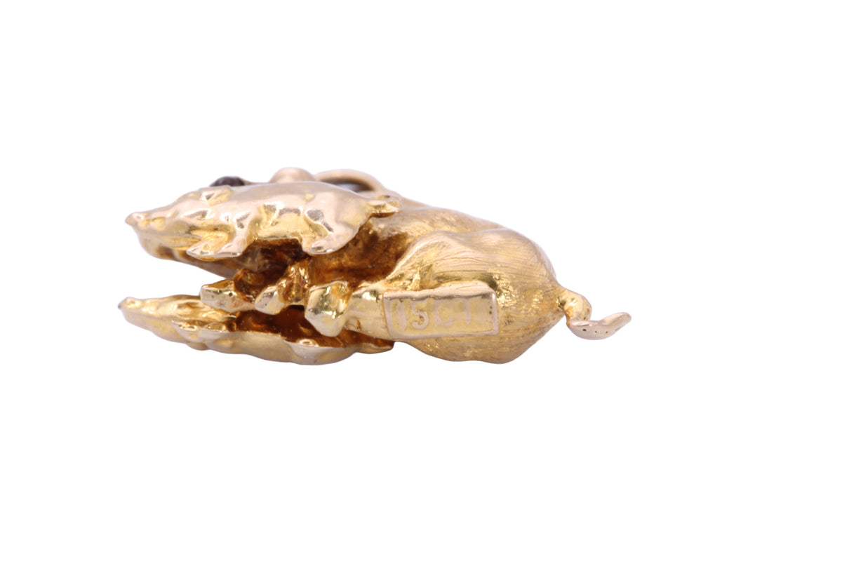 Antique 15ct gold pig and piglet charm shown in the hand
