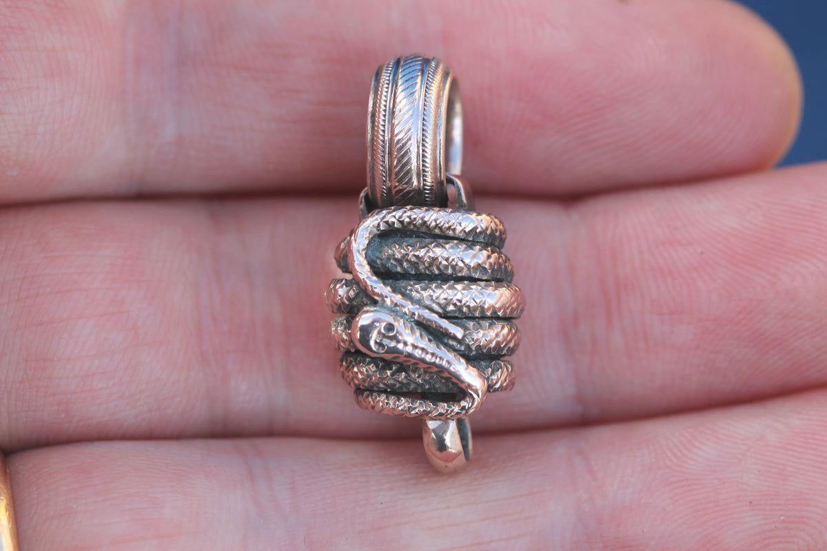 Close-up of Victorian gold snake wrapped around antique connector fitting
