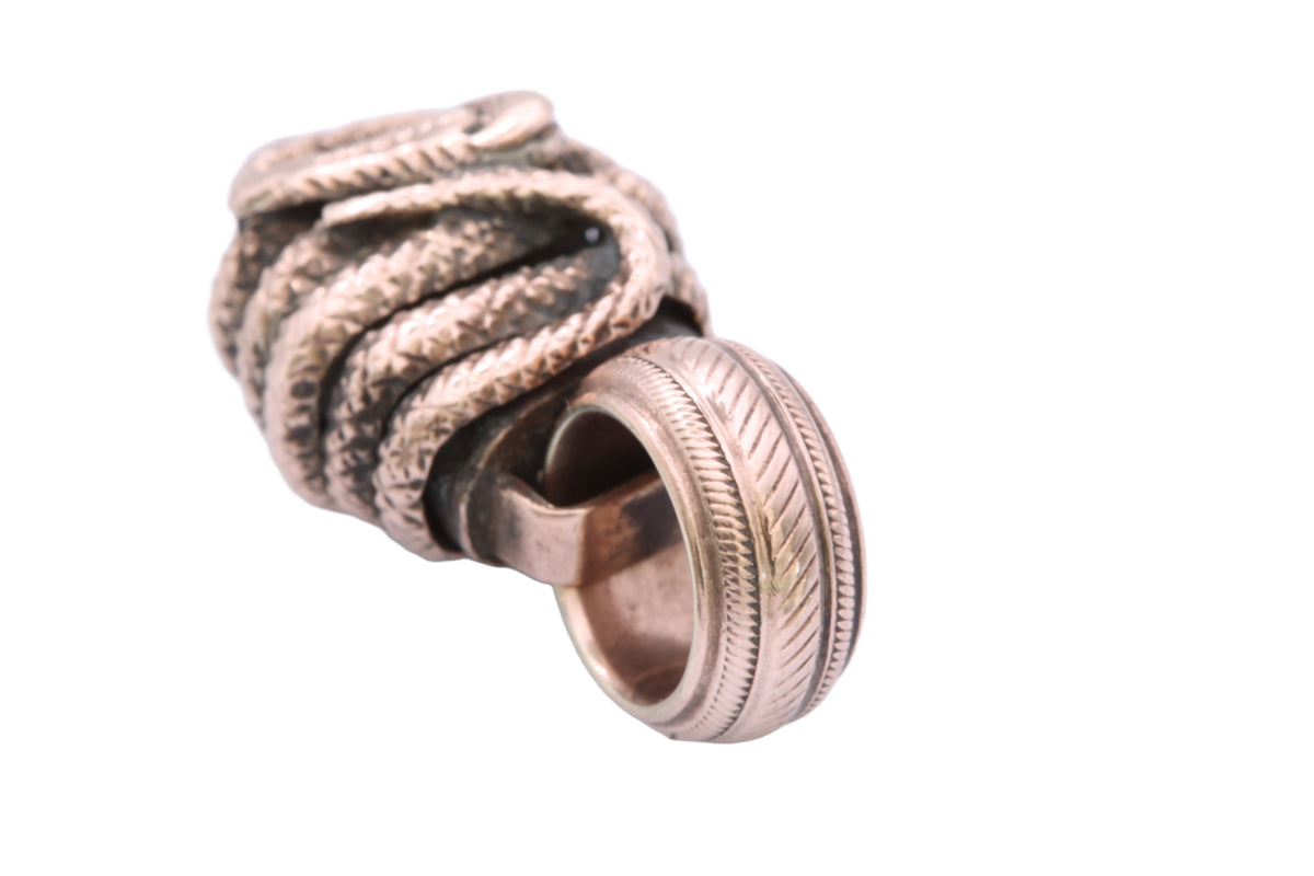 Antique 9ct gold snake connector pendant shown in the hand