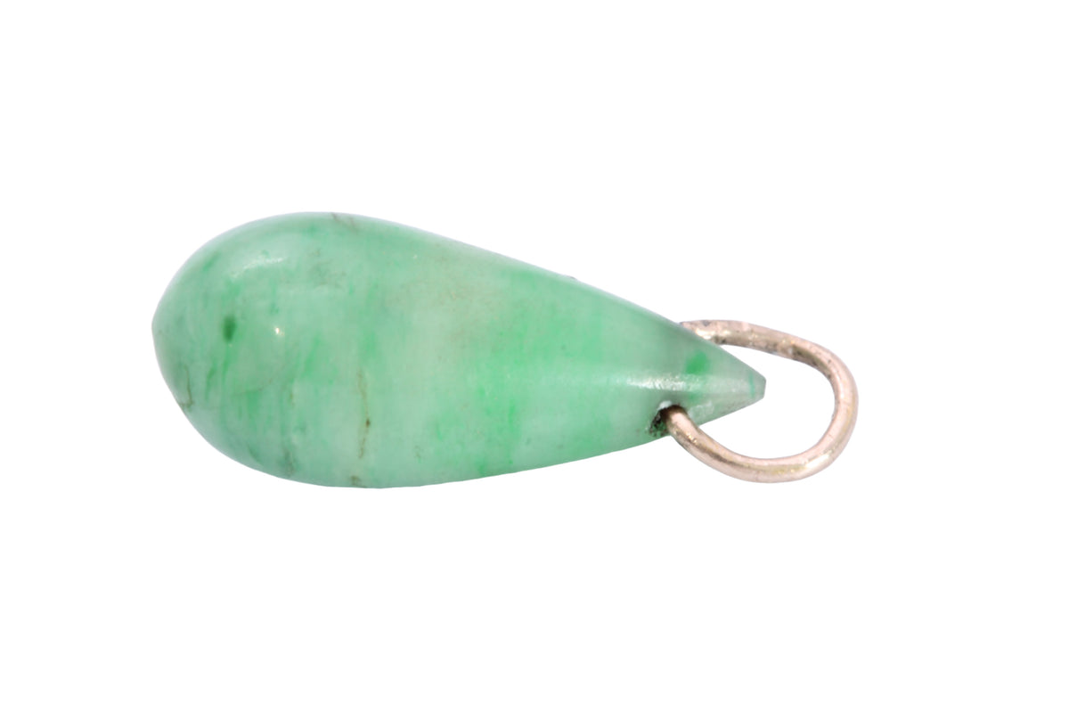 Close-up of green jade teardrop pendant showing natural mottling