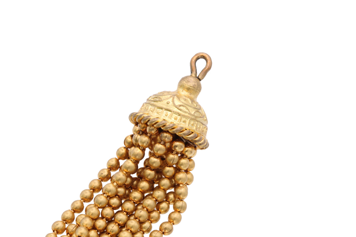 Close-up of Victorian tassel showing engraved domed cap and gold bead strands
