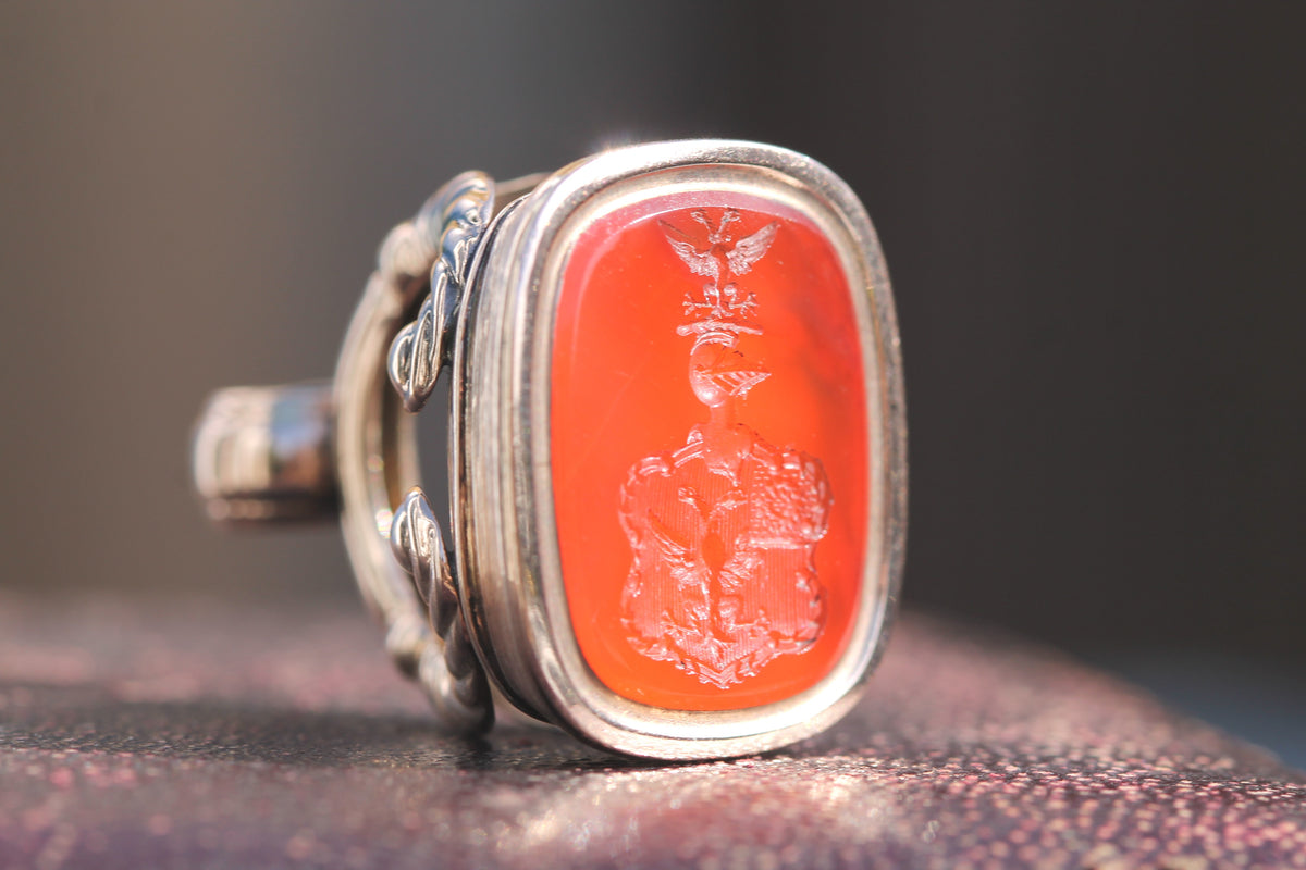 Carnelian intaglio engraved with heraldic coat of arms and crest