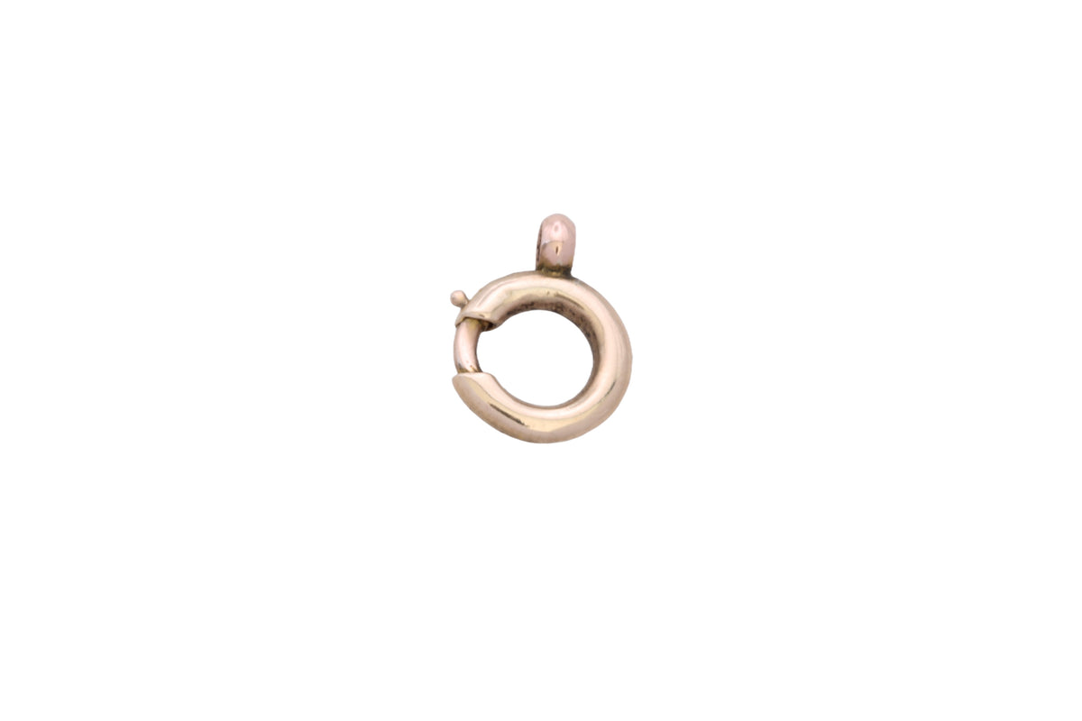 Close-up of small antique 9ct gold spring clasp in the hand