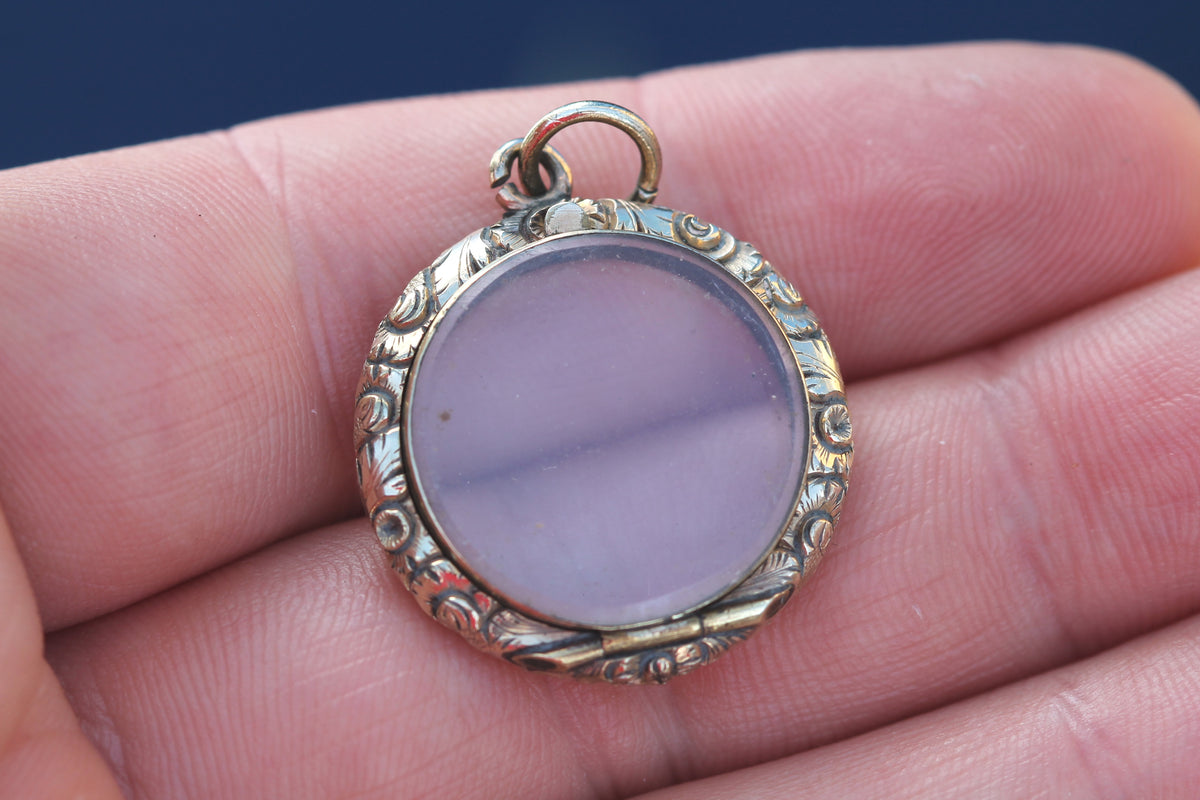 Side view of early Victorian chased glass keepsake locket