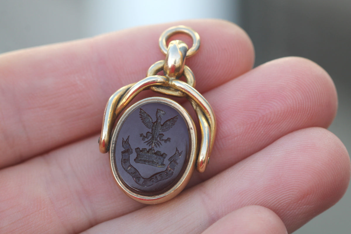 Close-up of bloodstone coat of arms and rising bird crest