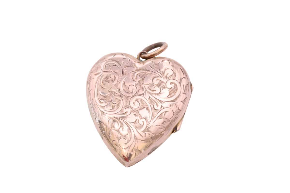Reverse of antique rose gold heart locket with foliate engraving