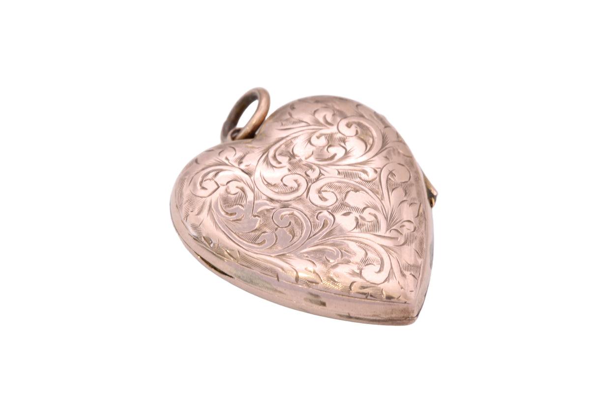 Open antique heart locket showing original internal inserts