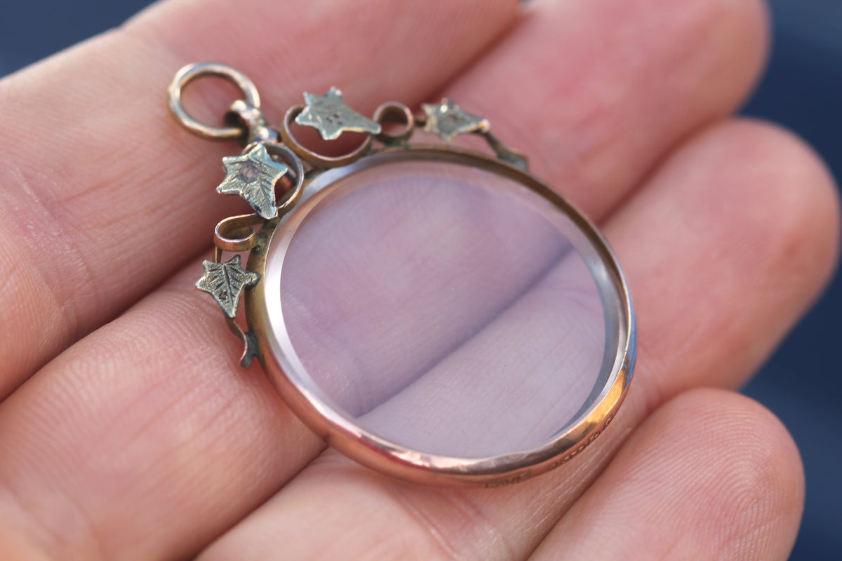 Antique glass locket opened with removable glass panel