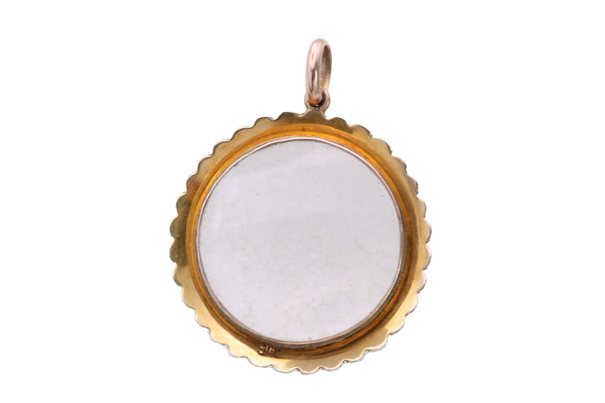 Victorian pearl locket held in hand showing clear central glass