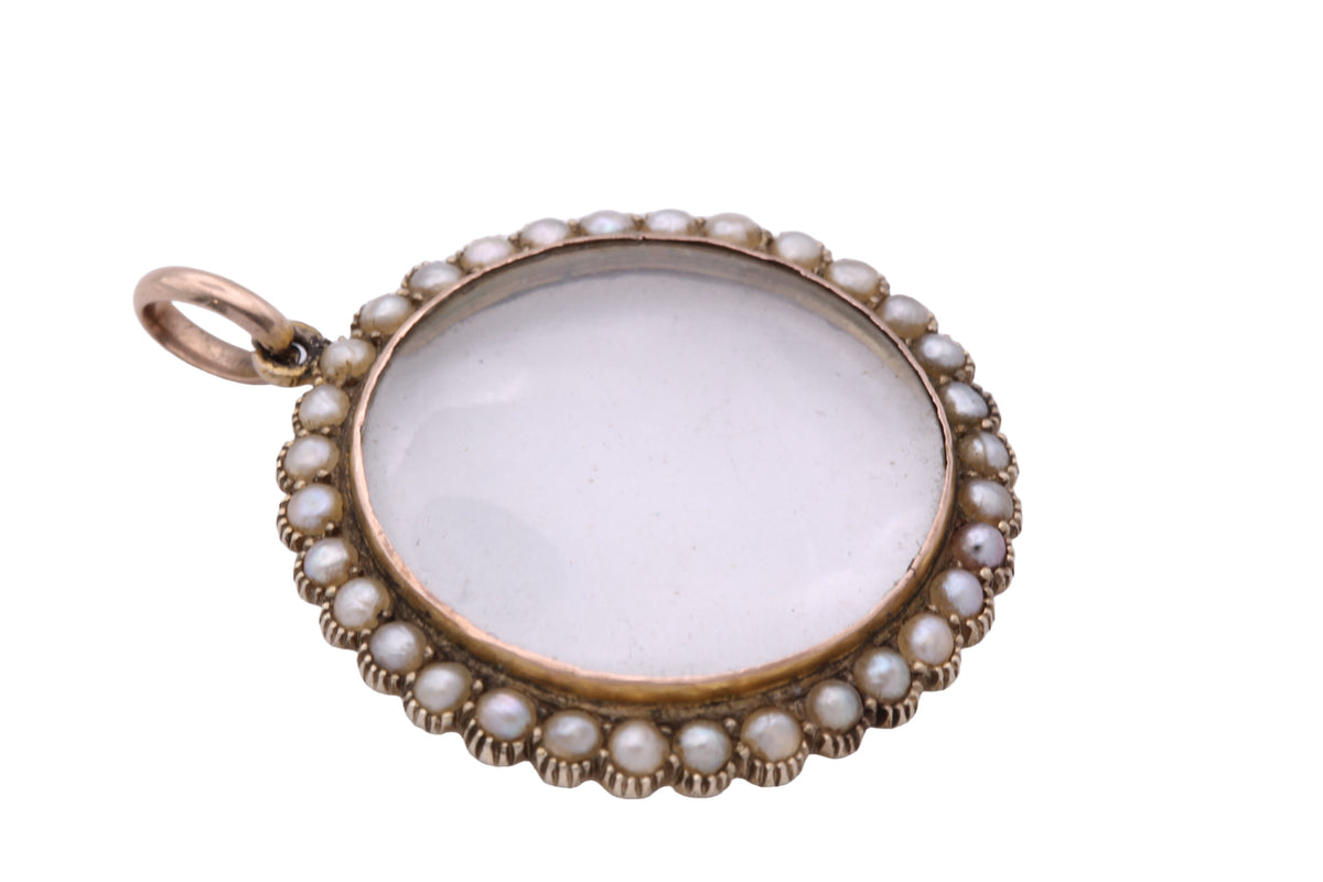 Open antique double glass locket showing removable glass panels