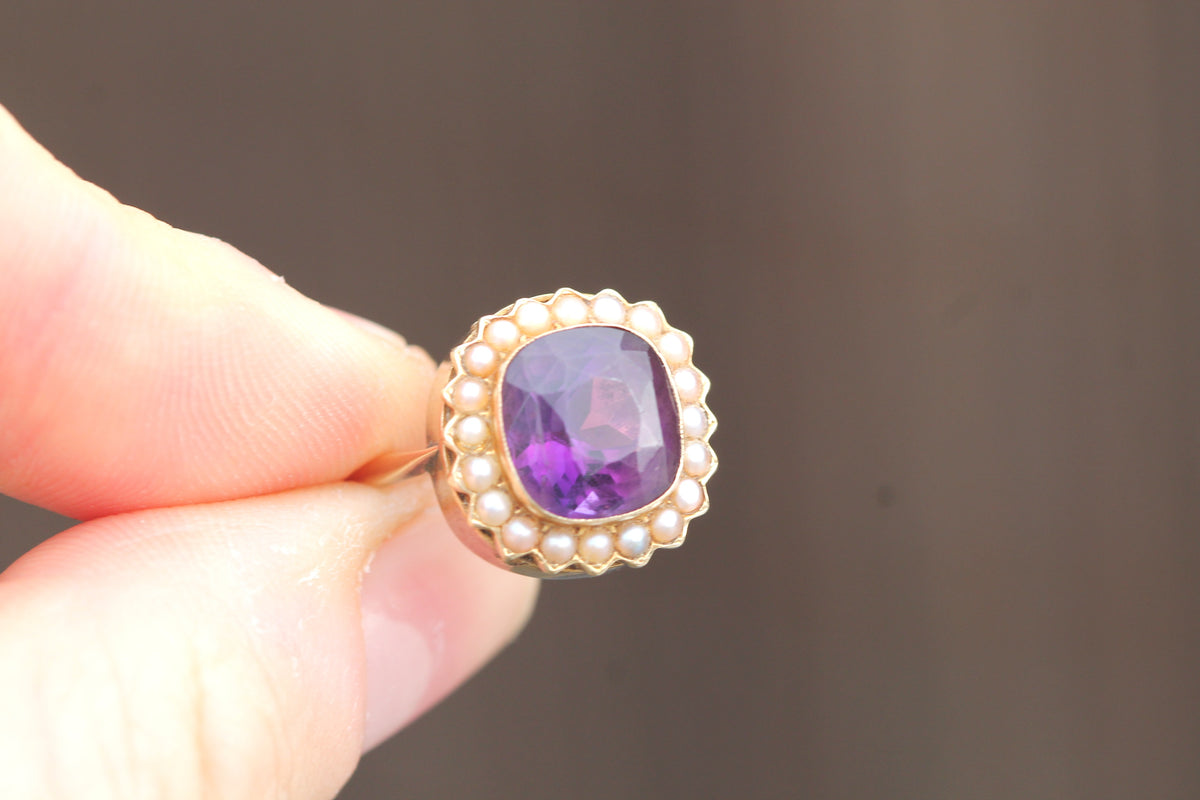 Victorian amethyst pearl cluster ring worn on the finger
