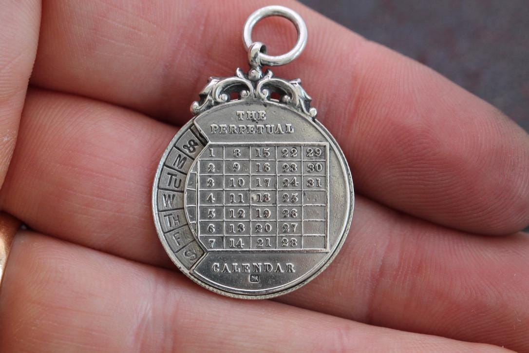 Antique Sterling Silver The Perpetual Calendar Pendant, 1899