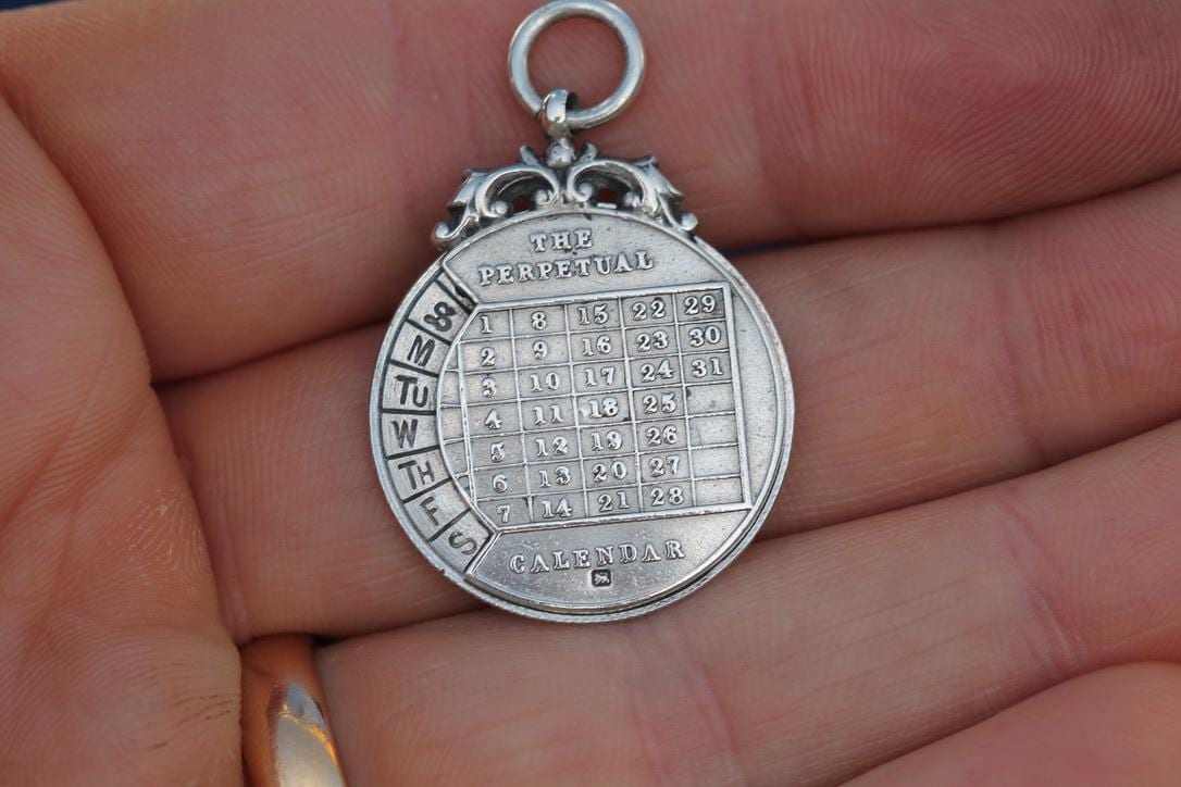Antique-Sterling-Silver-The-Perpetual-Calendar-Pendant,-1899