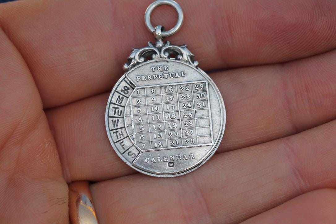 Antique-Sterling-Silver-The-Perpetual-Calendar-Pendant,-1899