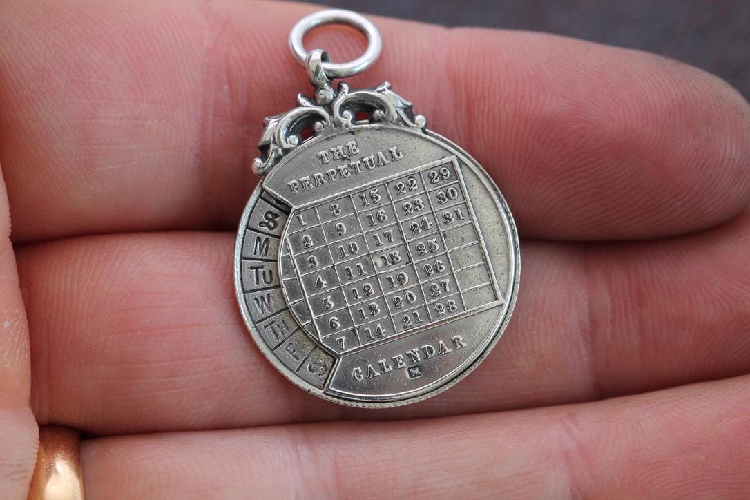 Antique Sterling Silver The Perpetual Calendar Pendant, 1899