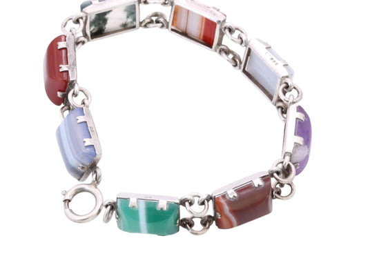 Vintage sterling silver bracelet showing pale blue banded and red polished stone panels with bolt clasp