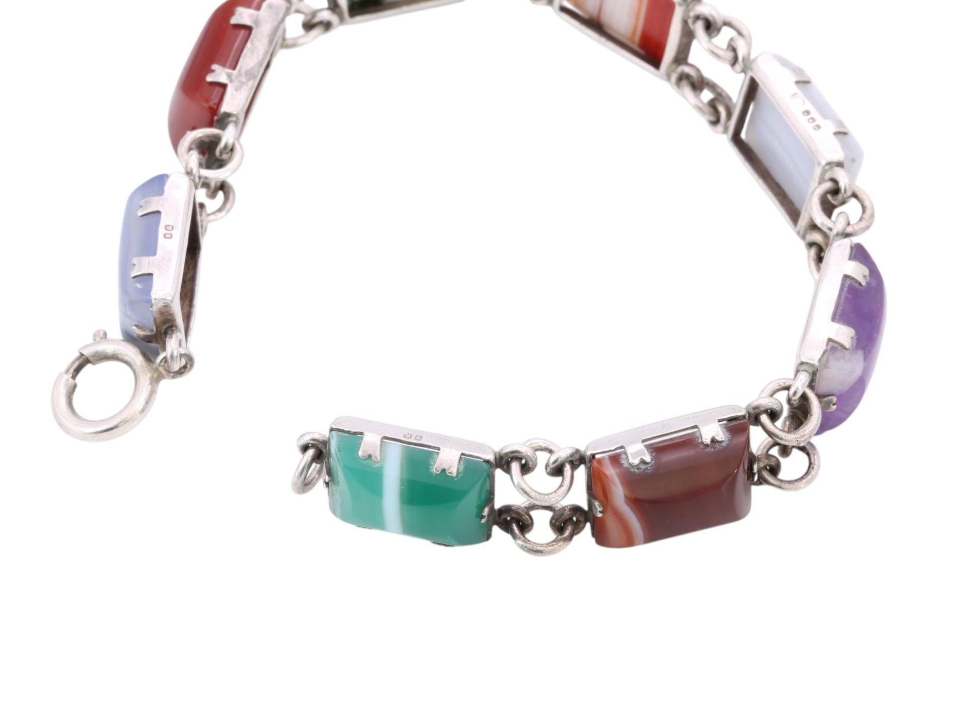 Sterling silver bracelet worn on the wrist showing moss agate and red stone panels