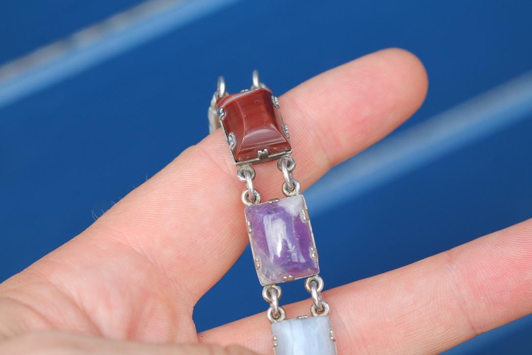 Scottish sterling silver bracelet showing multiple polished coloured stone panels