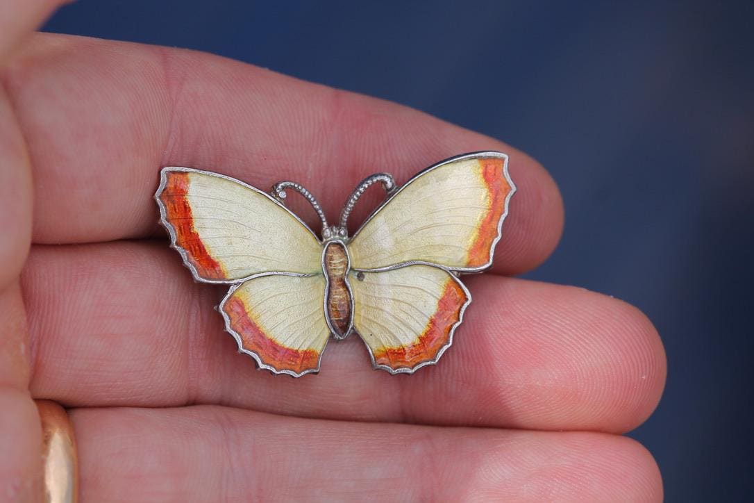 Reverse of butterfly brooch showing sterling silver stamp and pin fastening