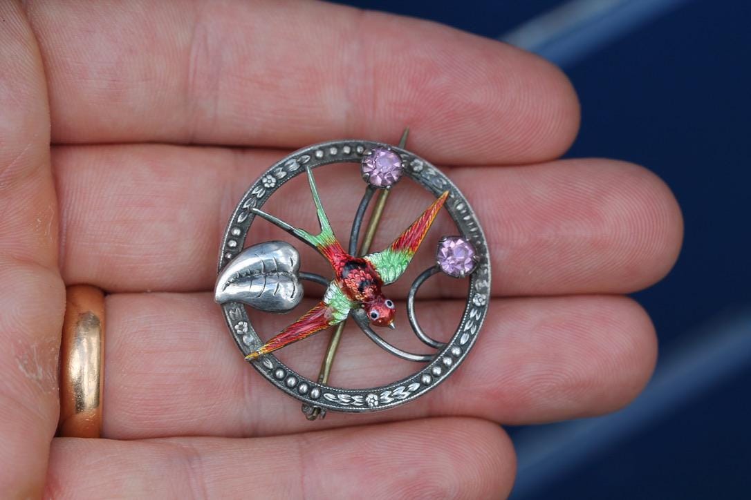 Reverse of sterling silver swallow brooch showing maker's marks and brass pin